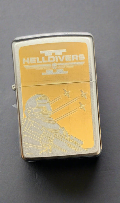 Front of lighter showing the Helldivers 2 logo above an image of a helldiver in uniform with three planes flying behind him